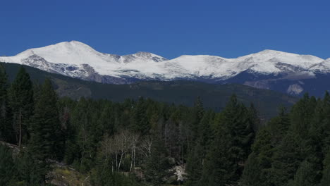 cinematic aerial drone zoom in first snow on denver mount blue sky evans 14er peak early autumn fall beautiful blue bird clear morning sunrise day colorado rocky mountains circle slowly right motion