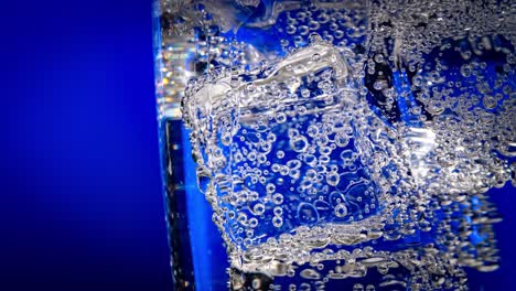 glass of water with ice on a dark blue background