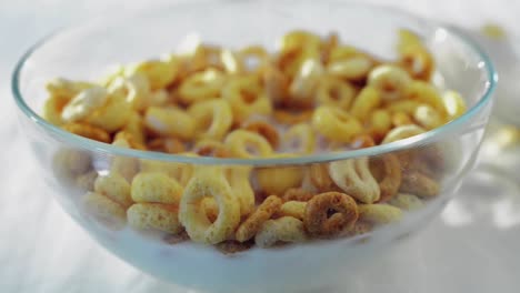 Milk-is-poured-onto-cereal-in-a-bowl