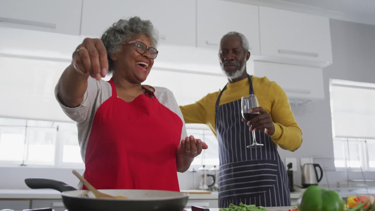 A senior African american couple cooking at home. Social distancing in quarantine