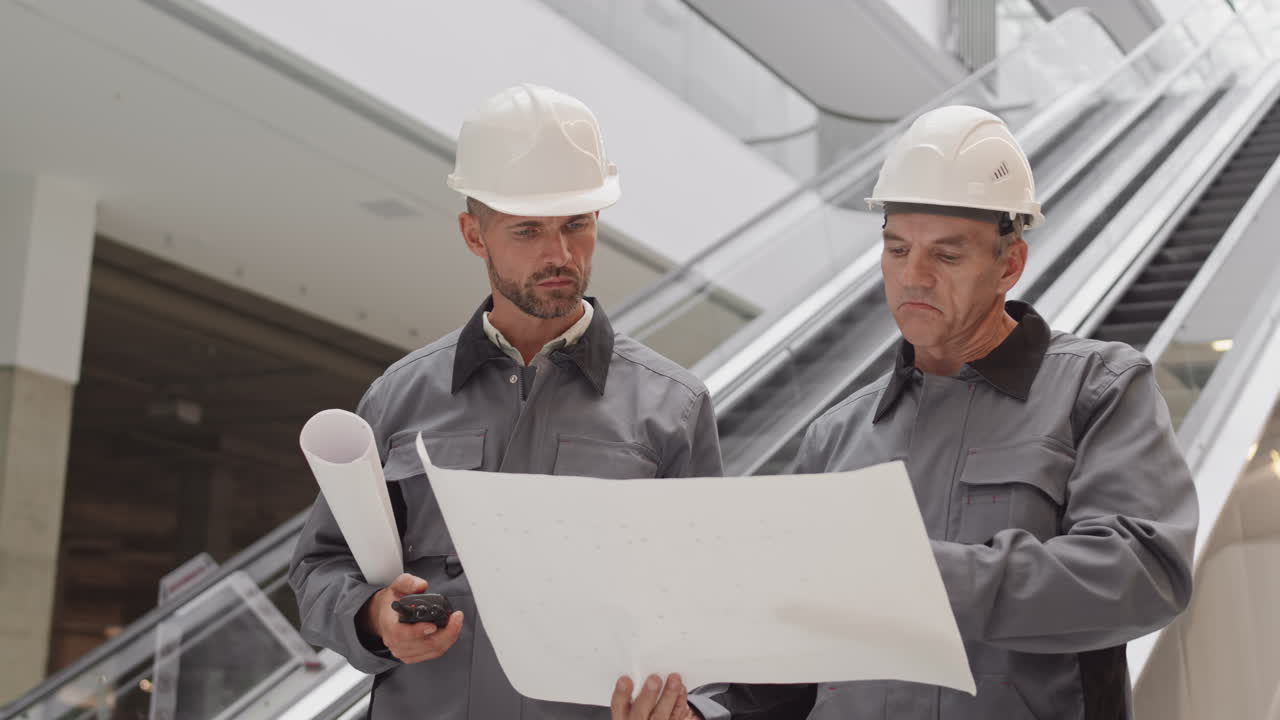 Construction Workers Talking by Escalator