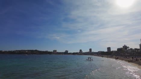 panoramic view of a bustling beach with a city skyline