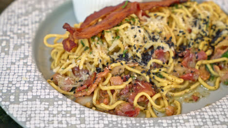 spaghetti aglio e olio with bacon - stir-fried spaghetti with garlic, olive oil, parsley, parmigiano-reggiano cheese tossed and bacon