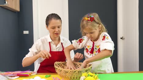 mother and daughter making an easter basket