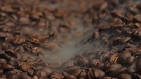 fragrant coffee beans are roasted smoke comes from coffee beans, video in 4k, 50fps