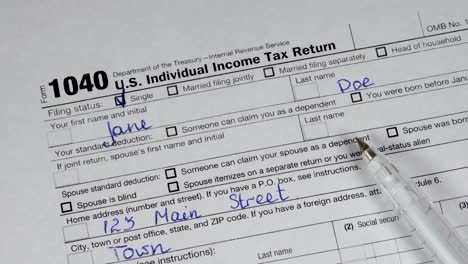 form 1040 u.s. individual income tax return with white pen