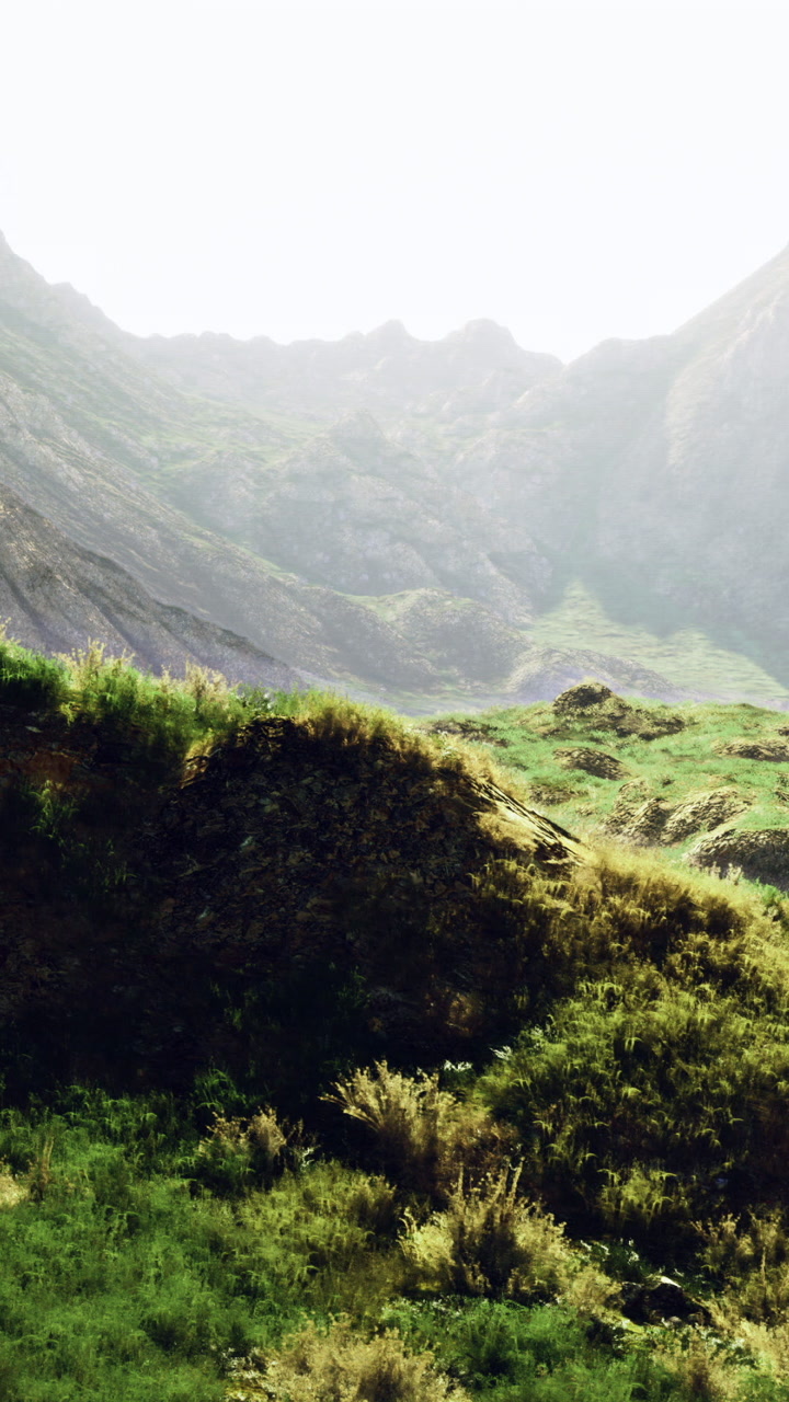 Mountain landscape with green hills and rocky terrain around noon