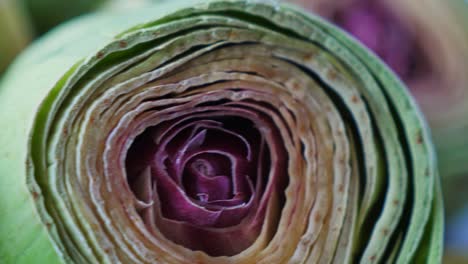 Cut-fresh-artichokes-on-plate,-rotating.-Closeup.-Nobody