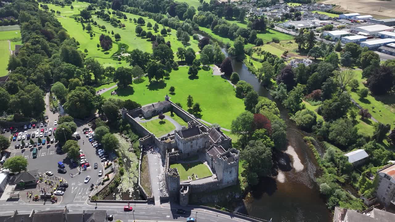 Cahir Castle aerial reveal to countryside of Co. Tipperary, nice sunny day in Ireland