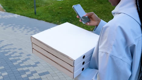 young woman holding paper bags on the street