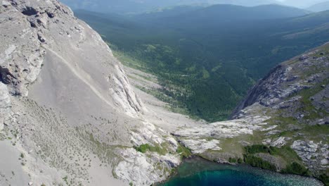 aerial fly over of carnarvon lake cliff waterfall, kananaskis, alberta, canada