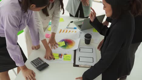 business people proficiently discuss work project on meeting table