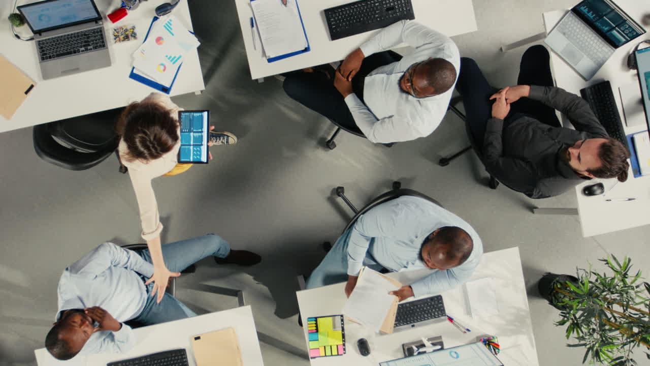 Vertical Video Top down view zoom in of business colleagues using computers to analyze insights