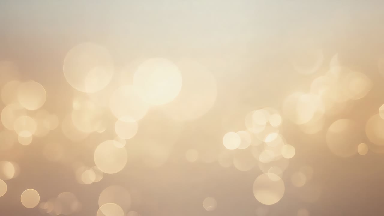 Brightening largest orb causing warm golden bokeh light orbs drifting in studio set, with soft glow