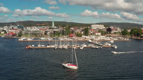 sailboat leaving harbour of kristiansand in norway