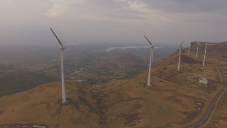 aerial shot of halted windmills producing no energy due to insufficient wind conditions