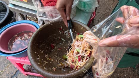 making spicy papaya salad in a mortar