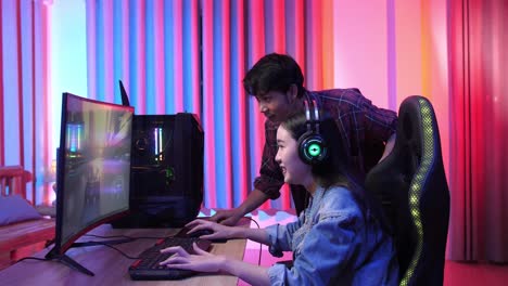 asian man actively talks and explains how to paly game to his friend
