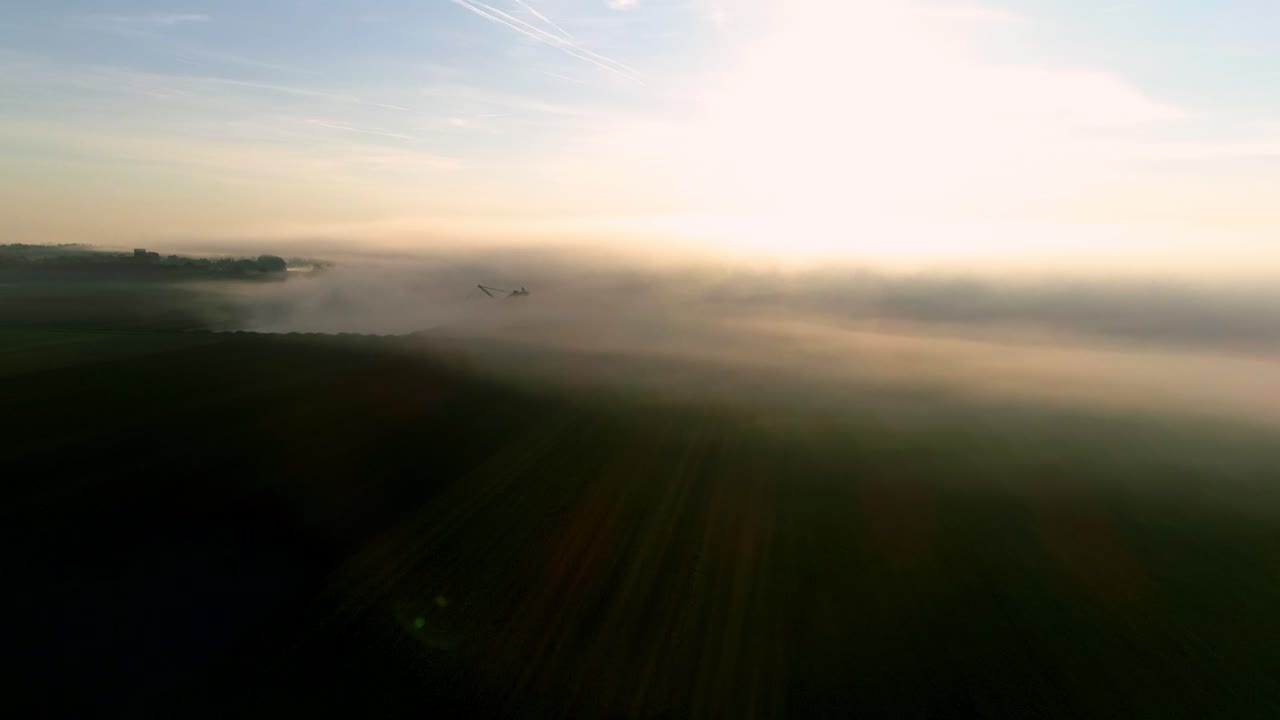 Beautiful footage of a pond and an excavator hidden in fog