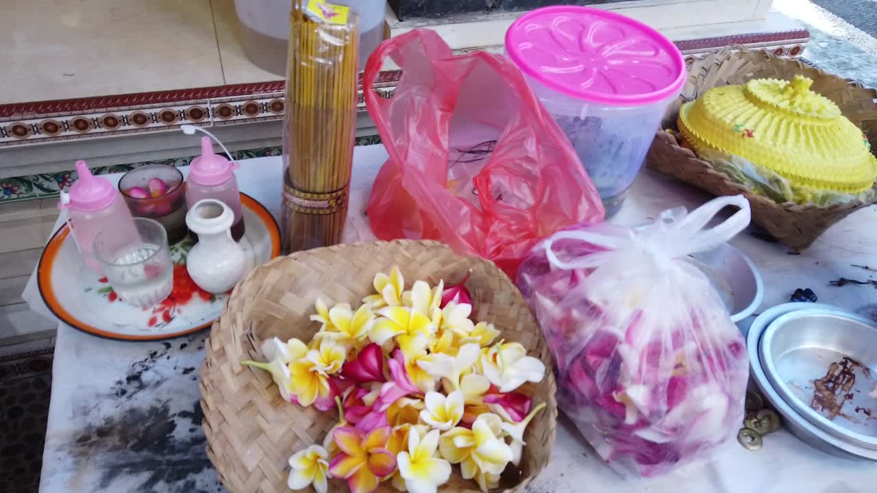 Balinese Frangipani Flowers Yellow, Pink, Holy Water, Priest Offerings Ceremony Sage for Praying in Hindu Religion, Bali Indonesia