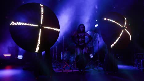 a girl stands on an industrial stage