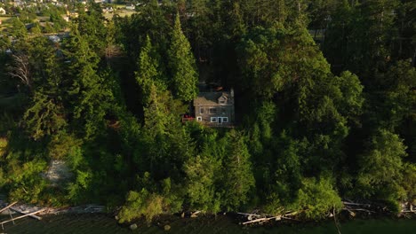 aerial view of a lone house on the coupeville shoreline overlooking penn cove