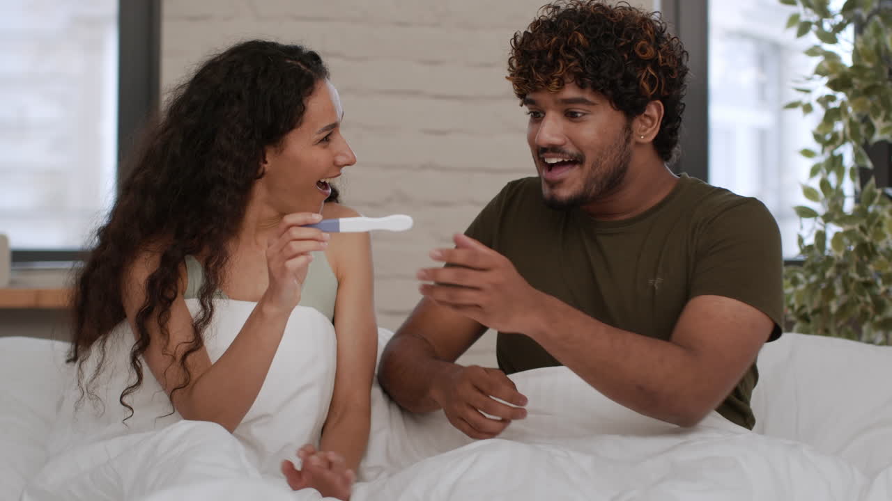 Happy Couple Looking at a Positive Pregnancy Test