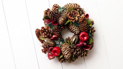 christmas wreath on white wooden background