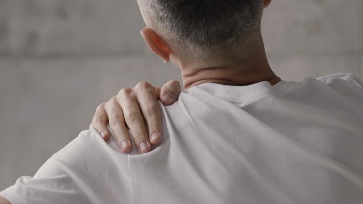 Suffering Man Having Shoulder Pain At Home