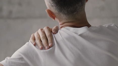 suffering man having shoulder pain at home