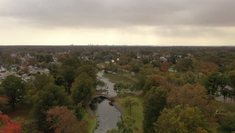 a high aerial shot over a pond on a cloudy day