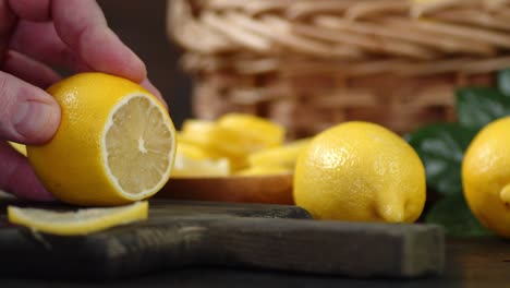 hands men cut fresh lemon into round slices.