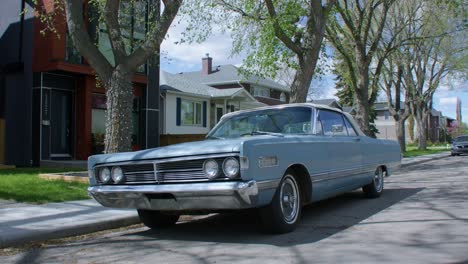 vintage car blue mercury parked on street tilt