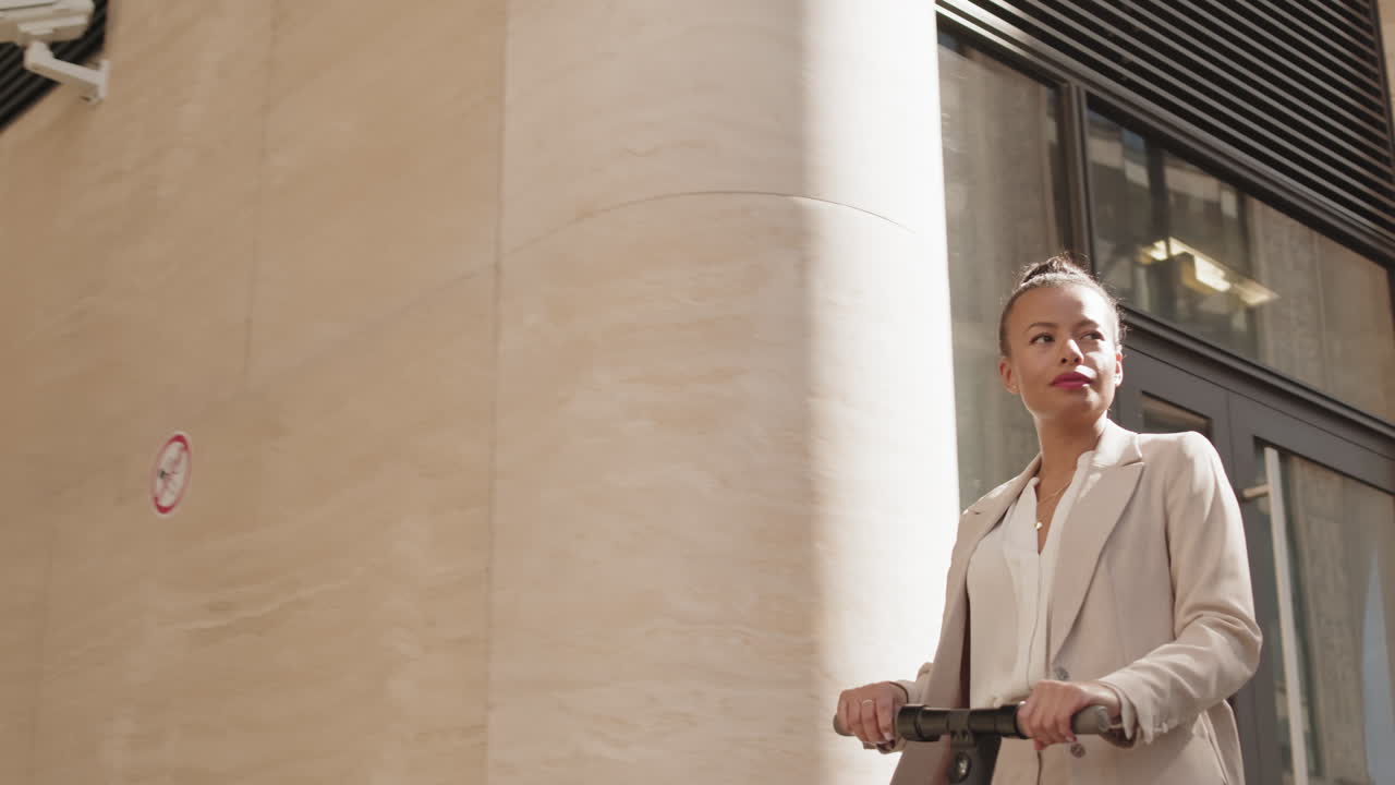 Businesswoman Riding E-Scooter in City Downtown