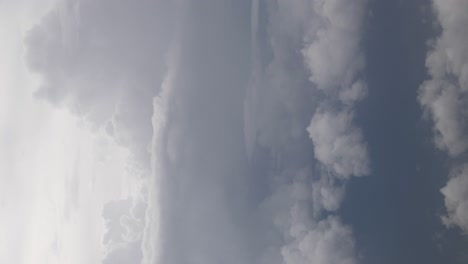 vertical view of sky while flying over fluffy cloud sky scape in daytime ,aerial view above the clouds and sky inspiration concept,natural background cloudscape