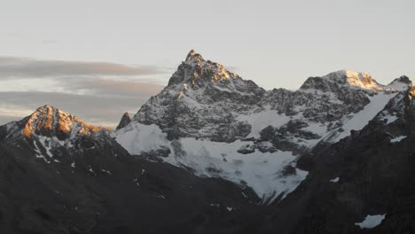 Snowy-mountain-peak-with-a-beautiful-glacier-in-amazing-sunset-light