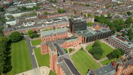 side-on reversing aerial video of queen's university belfast, in northern ireland, uk on a bright and sunny day. produced at 4k resolution, 60fps and with rec709 color.
