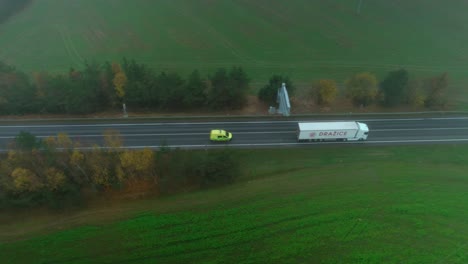 Aerial-drone-view-of-a-road-in-the-middle-of-Meadow