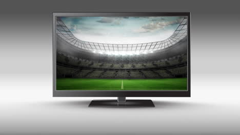 television with a football stadium on its screen