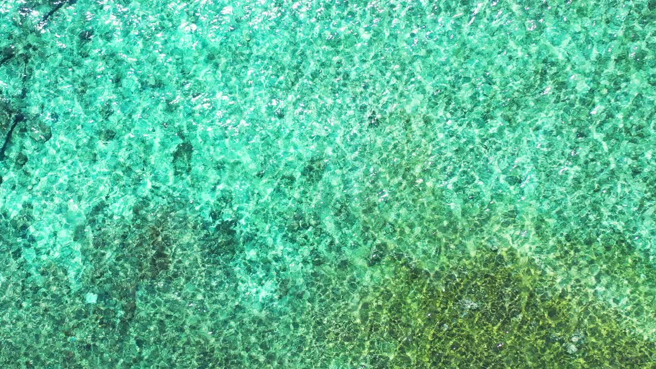 Hovering over crystal clear Waters. Beautiful turquoise seawater texture. aerial