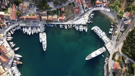 Picturesque-top-down-aerial-view,-greek-harbor-on-a-sunny-summer-day,-lowering