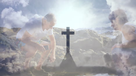 exploring rocky landscape, people walking under cloudy sky with cross silhouette