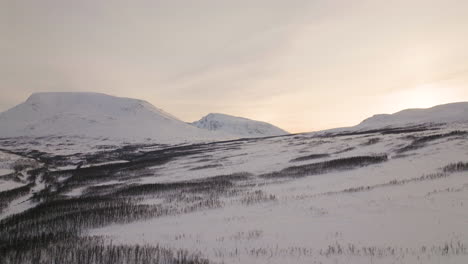 snowy northern norway valley landscape at sunset in winter, aerial