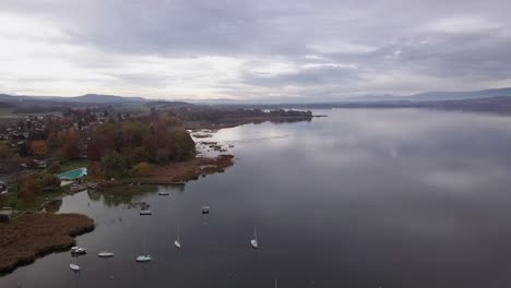 Aerial-drone-view-of-Lake-Murten,-Switzerland-in-a-cloudy-day