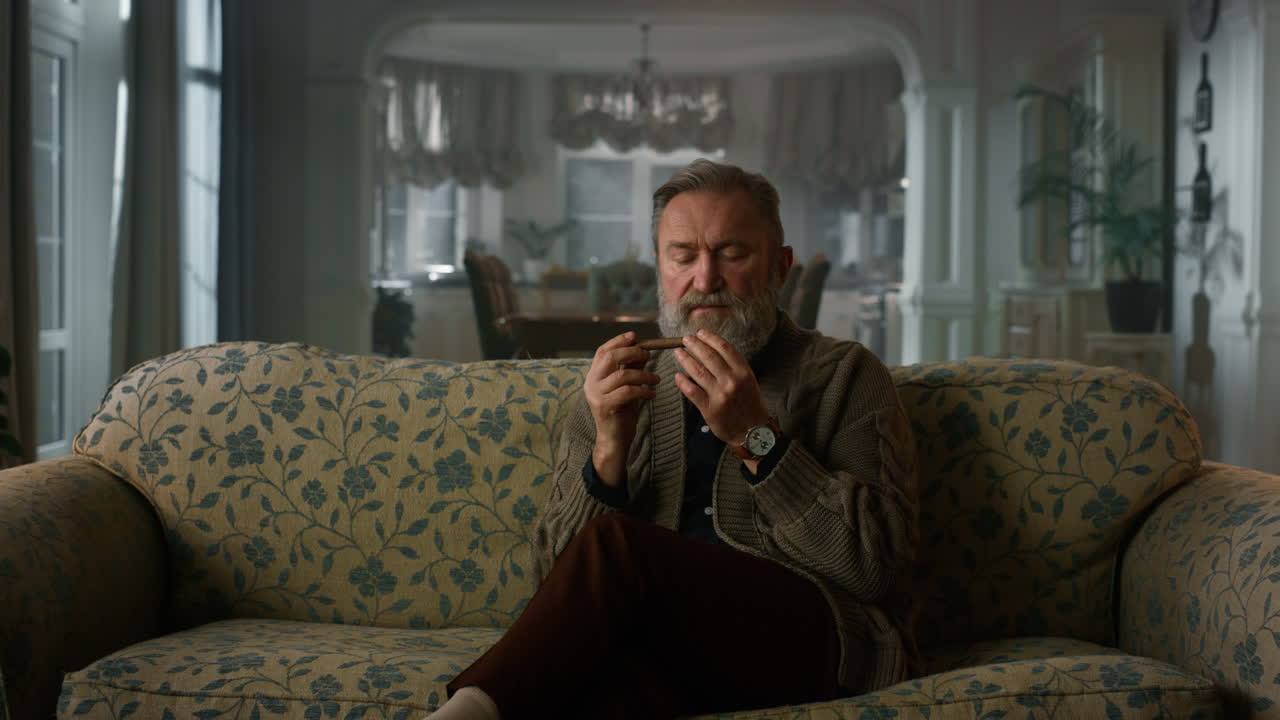 Senior gentleman smelling cuban cigar