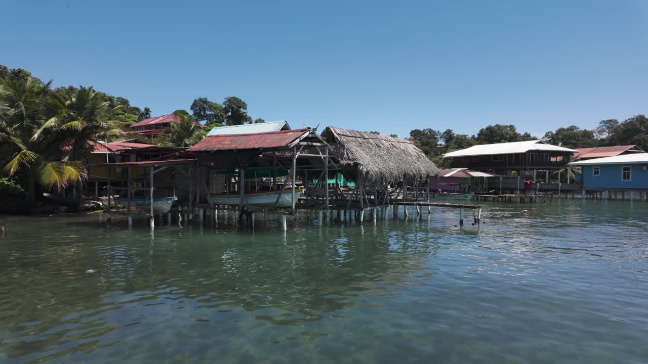 Scenic view of traditional coastal village huts over clear waters on Bastimentos Island, Bocas del Toro, Panama