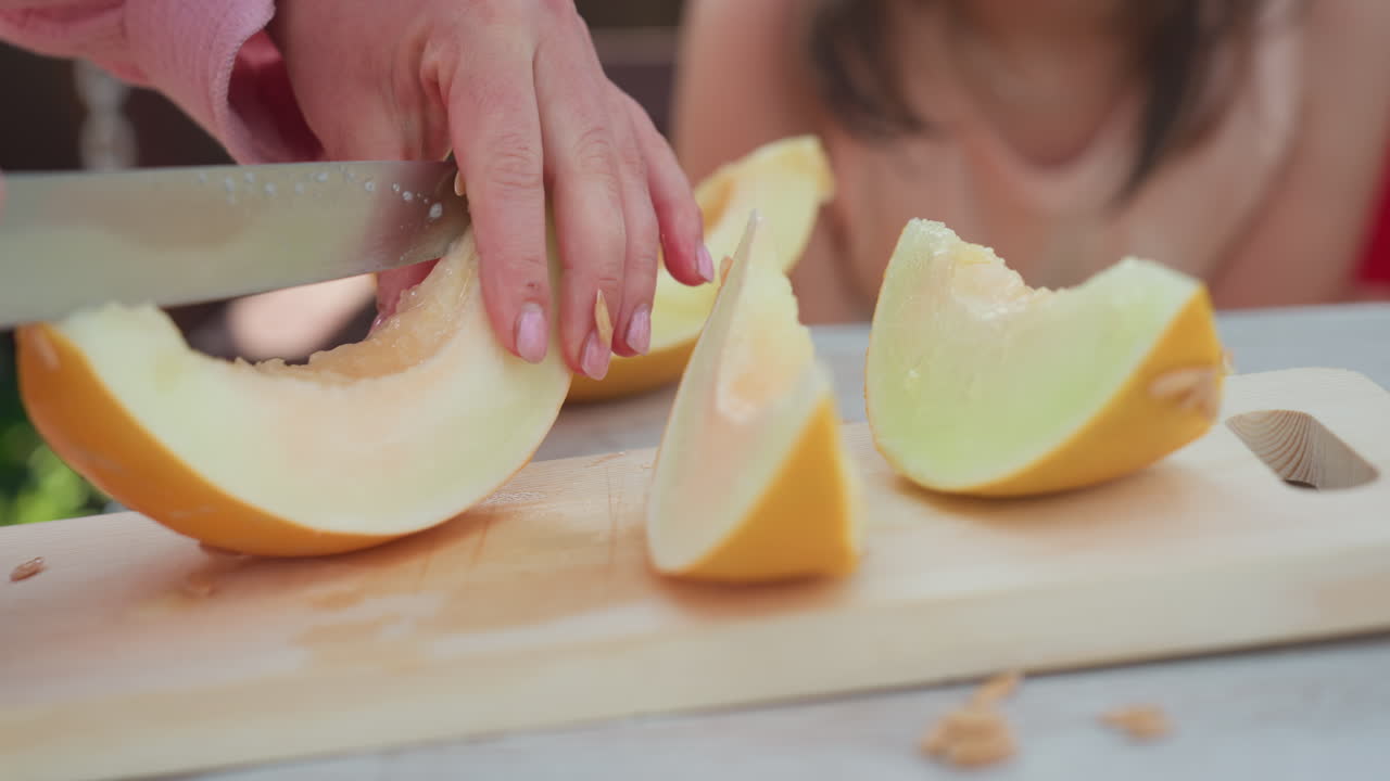 Guests And Kids Enjoying Colorful Summer Fruit Presentation Outdoors, Woman Prepares And Arranges Juicy Watermelon Segments On Wooden Table For Guests And Children To Enjoy During Summer Gathering