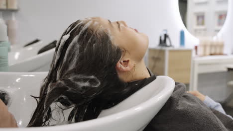 woman getting her hair washed at a salon
