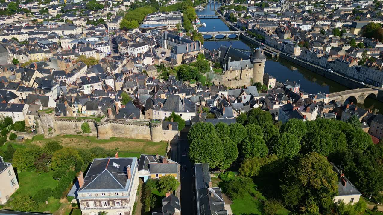 Wide drone approach of Laval featuring garden Perrine, Chateau Neuf, Chateau de Laval and river Mayenne