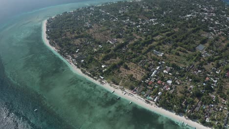 High-top-view-of-an-island-with-clear-blue-water-and-forest-at-backside-in-Thailand